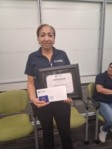 Female team member receiving certificate
